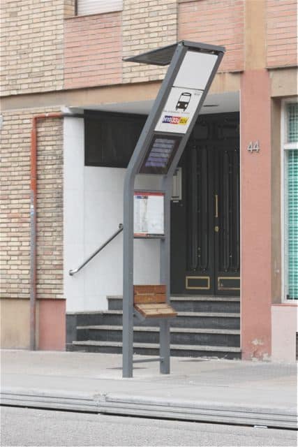 Smart bus stop: solar panel, arrival times, and seat.